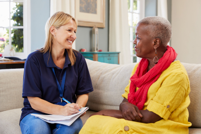 caregiver making company to her patient